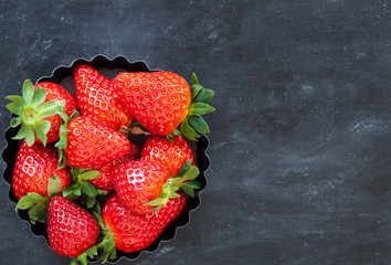 Fresh ripe strawberry on dark background
