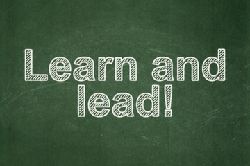 Fototapeta premium Education concept: Learn and Lead! on chalkboard background
