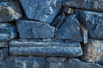 Abstract texture of a rustic vintage blue stone wall