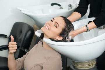 Happy client. Cropped shot of a stunning brunette enjoying hair washing at the local beauty salon