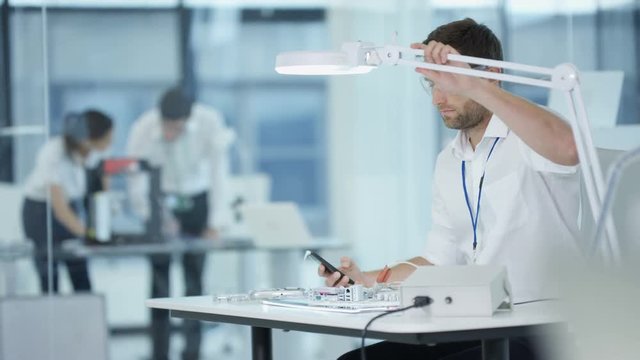  Electronics engineer working in lab building & testing electronic devices