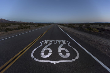 Route 66 pavement sign and desert dusk near Amboy California.  