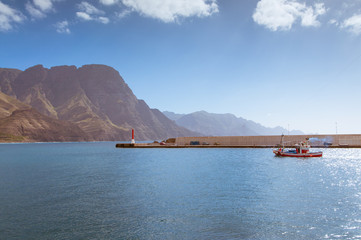 The fishing boat is sailing from the Puerto de las Nieves, Gran Canaria