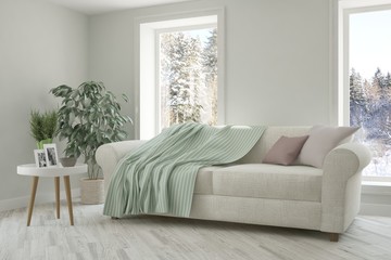 White room with sofa and winter landscape in window. Scandinavian interior design. 3D illustration