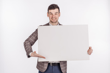 young man holding white blank panel with space for text on white background.