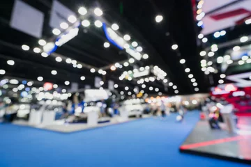 Deurstickers Blurred, defocused background of public event exhibition hall showing cars and automobiles, business commercial event concept © Urbanscape