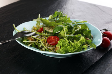 Bowl of salad on wooden table