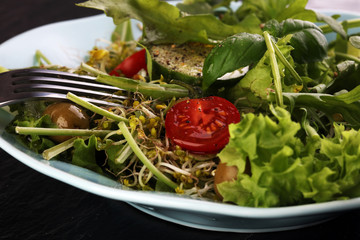 Bowl of salad on wooden table
