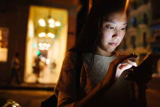 20 something uses cell phone GPS to find restaurant in Old Havana, Havana Cuba