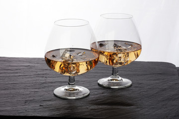glass of whiskey with ice on a wooden