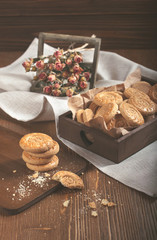 Lot of round biscuites and dry roses in wooden box