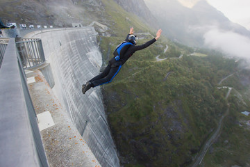 Basejumper jumping from the dam in Switzerland
