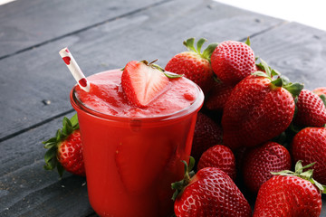 Fresh strawberry smoothie on wooden table