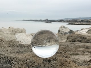 Fototapeta na wymiar Glass sphere on the rocks