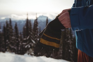 Midsection of man wearing gloves during winter