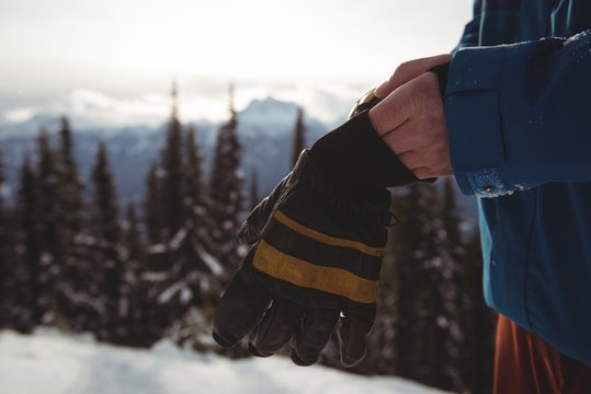 Midsection Of Man Wearing Gloves During Winter