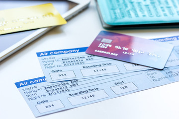 Credit cards with airline tickets for vacations on table background