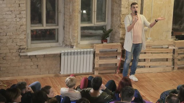 The funnyman telling a jokes on a stand-up show