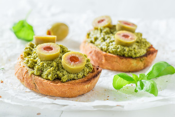 Fresh bruschetta with green olives for a snack