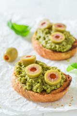 Crisp bruschetta with green olives for a breakfast