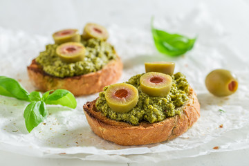 Crisp bruschetta with green olives for a snack