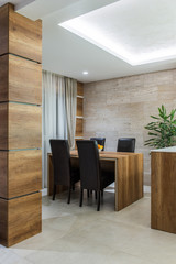 Woodn tabl and wooden pillar in dining room interior