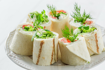 Delicious rolls with salmon, cheese and vegetables for a snack