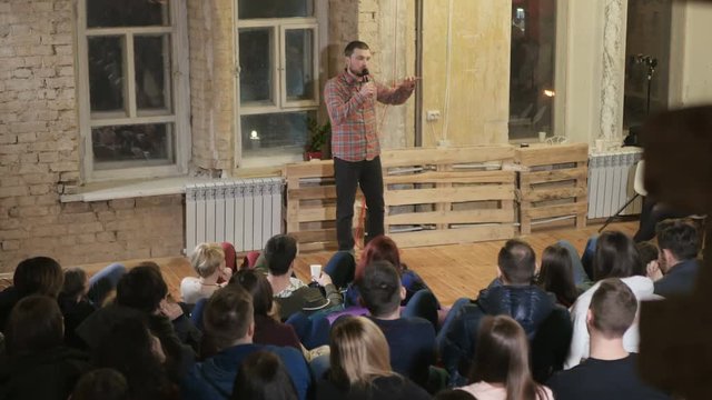 The funnyman telling a jokes on a comedy show