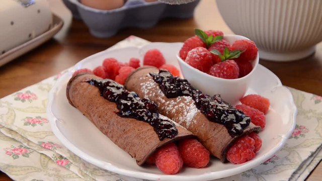 Delicious pancakes with berries and sugar