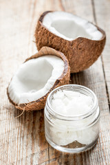 organic cosmetics with coconut on wooden background