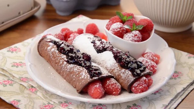 Delicious pancakes with berries and sugar