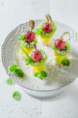 Tasty finger food with various fruits and mint for party