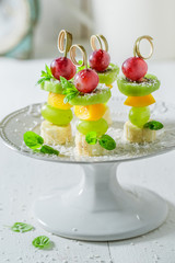 Tasty skewers with various fruits and mint for party