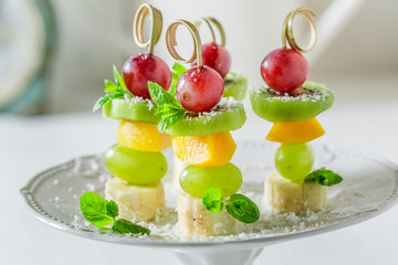 Homemade skewers with various fruits and mint for party