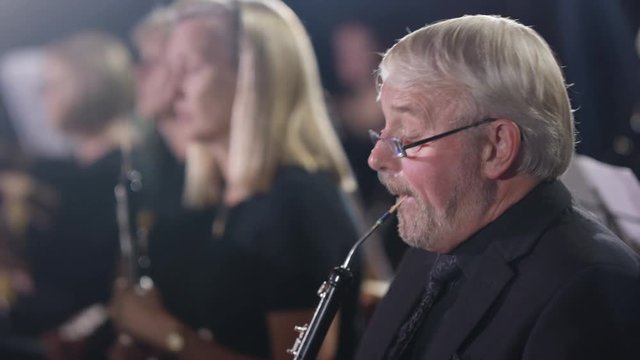  Symphony orchestra during a performance with focus on oboist. 