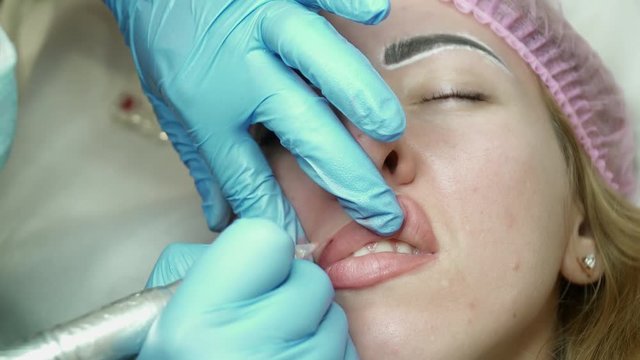Lip permanent makeup procedure closeup