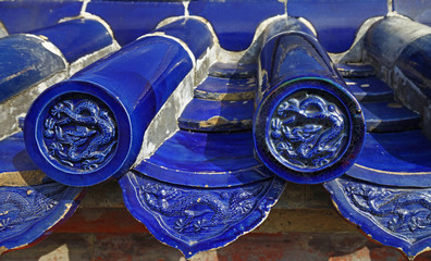 The blue glazed tiles on the wall as the background, the traditional architecture