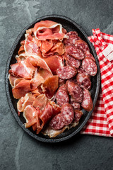 Plate of spanish meat tapas - jamon serrano and salamy