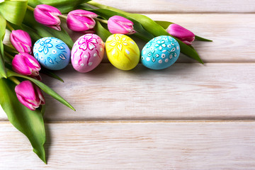 Easter background with decorated eggs  and tulips