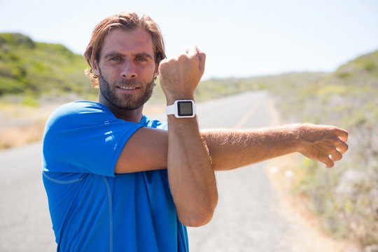 Portrait of athlete showing smart watch