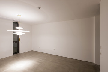 white empty room with big white pendant lighting, window