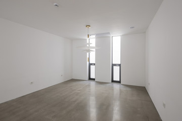 white empty room with big white pendant lighting, window