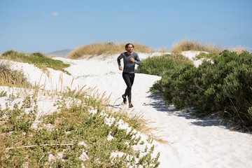 Athlete running at beach 