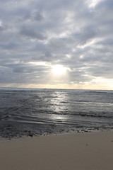 Sun poking out of clouds along Margaret River, Australia coastline