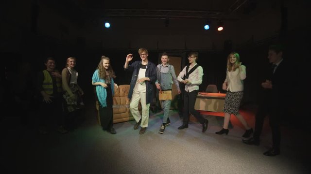  Student actors in school theatre production take a bow at end of performance