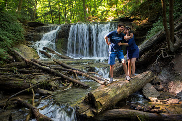 Fototapeta premium Mixed race couple take selfies at waterfall