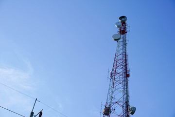 Silhouette, telecommunication towers with TV antennas and satellite dish