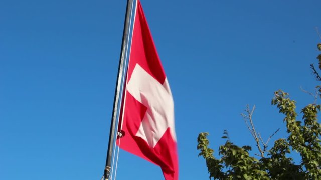 Aid Station, Field Hospital. Surgical Care To The Wounded In The War.  Red cross flag in the wind on mobile medical camp