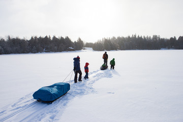 Mixed race family going ice fishing