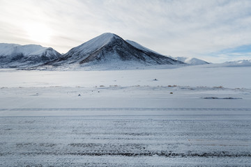 snow covered road in tibetan plateau